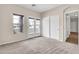 Comfortable bedroom with neutral carpet, a window and French doors, providing a bright and airy atmosphere at 27347 N Gary Rd, San Tan Valley, AZ 85144