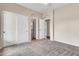 Spacious bedroom with neutral carpet, closet and open doorways, offering flexibility and ample storage at 27347 N Gary Rd, San Tan Valley, AZ 85144
