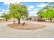 Charming stucco home featuring a spacious driveway and an attached two-car garage with mature desert landscaping at 27347 N Gary Rd, San Tan Valley, AZ 85144