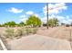 Desert home's entrance, complemented by natural landscaping and a clear blue sky, embodying serene desert living at 27347 N Gary Rd, San Tan Valley, AZ 85144