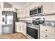 Modern kitchen with stainless steel appliances, granite countertops, and ample cabinet space at 27347 N Gary Rd, San Tan Valley, AZ 85144