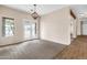 A large living room with carpeting features backyard views and designer light fixture at 27347 N Gary Rd, San Tan Valley, AZ 85144