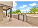 The covered patio features a decorative iron gate and beautiful landscape views at 27347 N Gary Rd, San Tan Valley, AZ 85144
