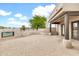 Spacious back patio with brick pavers and outdoor seating area overlooking mature tree at 27347 N Gary Rd, San Tan Valley, AZ 85144