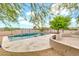Backyard pool with elegant tiling and desert landscaping, providing a luxurious and inviting outdoor oasis at 27347 N Gary Rd, San Tan Valley, AZ 85144