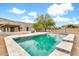Backyard pool with a tranquil water feature and surrounding desert landscaping, perfect for relaxation and entertainment at 27347 N Gary Rd, San Tan Valley, AZ 85144