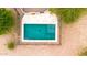 A serene pool area provides a private desert oasis, complemented by stylish stone decking and iron safety fencing at 27347 N Gary Rd, San Tan Valley, AZ 85144
