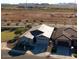 Aerial view showcasing the home's roof, two-car garage, desert landscaping, and proximity to nearby construction at 32582 N Durango Ln, San Tan Valley, AZ 85143