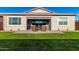 Lush backyard featuring green grass, patio seating, and inviting outdoor living space at 32582 N Durango Ln, San Tan Valley, AZ 85143