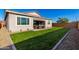 Beautiful backyard featuring a lush green lawn, covered patio, and well-manicured landscaping at 32582 N Durango Ln, San Tan Valley, AZ 85143