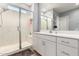 Bright bathroom featuring a glass door shower, quartz countertop and white vanity at 32582 N Durango Ln, San Tan Valley, AZ 85143