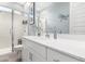 Bright bathroom featuring white vanity, framed mirror, decorative dragonfly and glass-enclosed shower at 32582 N Durango Ln, San Tan Valley, AZ 85143