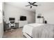 Comfortable bedroom with a ceiling fan, a white-painted dresser, and an adjacent desk area at 32582 N Durango Ln, San Tan Valley, AZ 85143