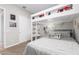 bedroom with a bunk bed, a desk, and a sliding door at 32582 N Durango Ln, San Tan Valley, AZ 85143
