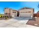 Well-maintained home featuring a two car garage, concrete driveway and desert landscaping at 32582 N Durango Ln, San Tan Valley, AZ 85143