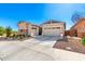 Well-maintained home featuring a two car garage, concrete driveway and desert landscaping at 32582 N Durango Ln, San Tan Valley, AZ 85143