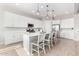 Modern kitchen with white cabinetry, a center island with seating, and stainless steel appliances at 32582 N Durango Ln, San Tan Valley, AZ 85143