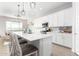 This kitchen has stylish pendant lights over a large center island with bar stool seating at 32582 N Durango Ln, San Tan Valley, AZ 85143