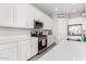 This kitchen boasts white cabinets, stainless steel appliances, and elegant countertops at 32582 N Durango Ln, San Tan Valley, AZ 85143