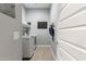 Functional laundry room with modern washer/dryer, shelving, and a convenient organization calendar at 32582 N Durango Ln, San Tan Valley, AZ 85143