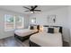Bright bedroom featuring two twin beds, modern ceiling fan, and plenty of natural light at 343 S Cholla St, Gilbert, AZ 85233