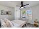 Bright bedroom with a large windows, white bedding, and closet space, creates a cozy and inviting atmosphere at 343 S Cholla St, Gilbert, AZ 85233