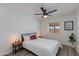 Cozy bedroom featuring a ceiling fan, a comfortable bed, and natural light from the window at 343 S Cholla St, Gilbert, AZ 85233
