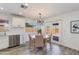 Dining area with a table, chairs, and light fixture, next to an open kitchen with modern appliances and cabinets at 343 S Cholla St, Gilbert, AZ 85233