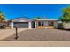Charming single-story home featuring a gray garage door, well-kept landscaping, and sunny sky, situated in a quiet neighborhood at 343 S Cholla St, Gilbert, AZ 85233