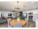 A spacious living room features a dining area, kitchen, gray sofa, and a flat screen television at 343 S Cholla St, Gilbert, AZ 85233
