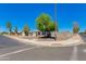 A neighborhood street view features a charming home with well-maintained landscaping, a utility pole, and clear blue skies above at 343 S Cholla St, Gilbert, AZ 85233