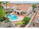 Inviting backyard features refreshing pool, covered patio, and mature landscaping creating a private outdoor oasis at 4043 N Ranier --, Mesa, AZ 85215