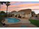 Resort-style backyard with a large pool, covered patio, and desert landscaping at 4043 N Ranier --, Mesa, AZ 85215