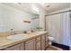 Well-lit bathroom with a double sink vanity, tile countertops, and a shower-tub combo at 4043 N Ranier --, Mesa, AZ 85215