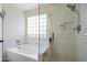 This bathroom features a glass-enclosed shower, soaking tub, and a rain shower head at 4043 N Ranier --, Mesa, AZ 85215
