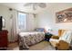 Cozy bedroom featuring a patterned bedspread, framed art, and an abundance of natural light at 4043 N Ranier --, Mesa, AZ 85215