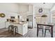 Well-lit kitchen with white cabinetry, stainless appliances, and a breakfast bar at 4043 N Ranier --, Mesa, AZ 85215