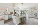 Well-lit kitchen with white cabinetry, stainless appliances, and a breakfast bar at 4043 N Ranier --, Mesa, AZ 85215