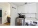 Convenient laundry room with modern appliances and ample cabinet storage, with a bathroom view at 4043 N Ranier --, Mesa, AZ 85215