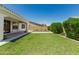Large grassy backyard with tile features at 4051 S Galaxy Ln, Mesa, AZ 85212