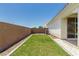 Neat backyard featuring a grass lawn, desert landscaping, and a concrete perimeter at 4051 S Galaxy Ln, Mesa, AZ 85212