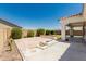 Backyard with a tiled patio area and built in firepit at 4051 S Galaxy Ln, Mesa, AZ 85212