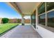 Inviting covered patio overlooking a well-maintained backyard with a grass lawn at 4051 S Galaxy Ln, Mesa, AZ 85212