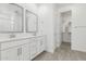 Bathroom with double vanity, dual mirrors, and walk-in shower, plus access to walk-in closet at 4051 S Galaxy Ln, Mesa, AZ 85212