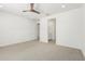Spacious bedroom with neutral carpet, ceiling fan, and view into en-suite bathroom and walk-in closet at 4051 S Galaxy Ln, Mesa, AZ 85212