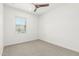 Carpeted bedroom featuring a window for natural light and a ceiling fan at 4051 S Galaxy Ln, Mesa, AZ 85212