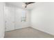 Small bedroom offers neutral carpet, a ceiling fan and a window at 4051 S Galaxy Ln, Mesa, AZ 85212