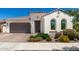 Charming single-story home with a brown tile roof, arched windows and a two car garage at 4051 S Galaxy Ln, Mesa, AZ 85212