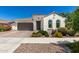 Charming single-story home with a brown tile roof, arched windows and a two car garage at 4051 S Galaxy Ln, Mesa, AZ 85212