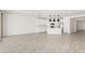 Open floor plan with white kitchen, island and stainless steel appliances overlooking the living area at 4051 S Galaxy Ln, Mesa, AZ 85212